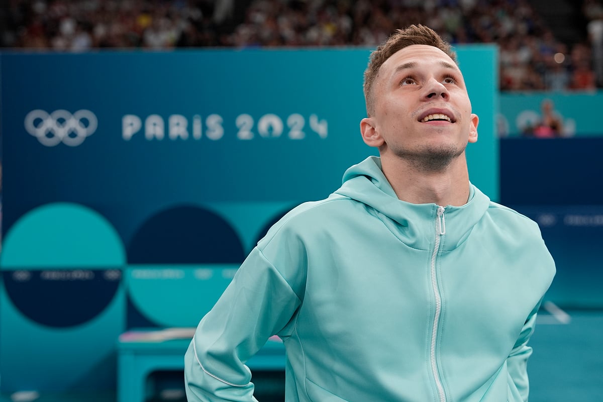Ivan Litvinovich of the Individual Neutral Athletes watches scores after winning the gold medal during the men's trampoline finals in Bercy Arena at the 2024 Summer Olympics, Friday, Aug. 2, 2024, in Paris, France.  - (AP PhotoCharlie Riedel)