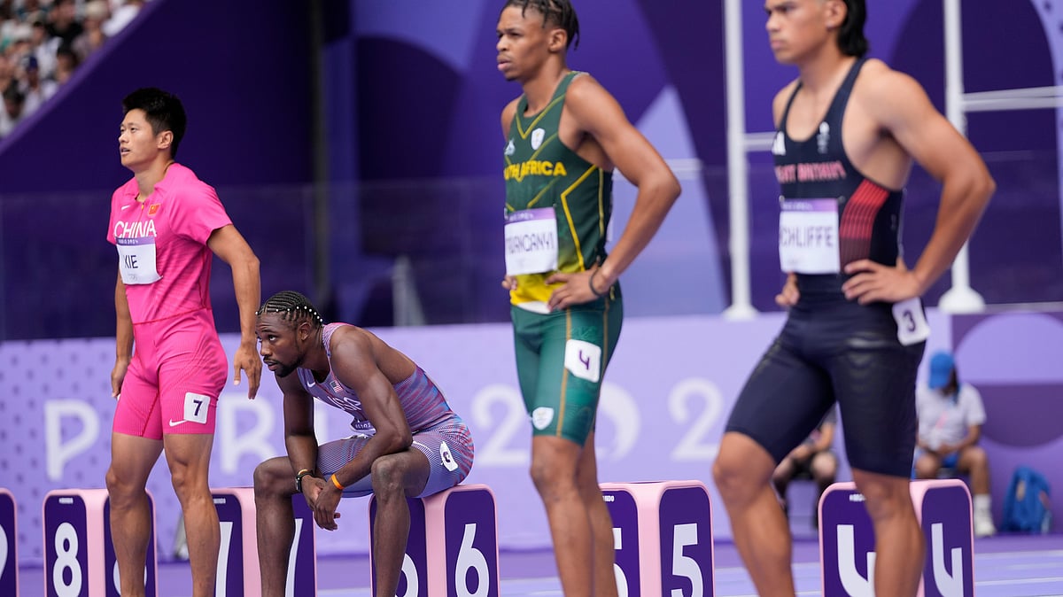 AP Photo/Bernat Armangue : Noah Lyles, of the United States, prepares for his heat in the men's 100-meters at the 2024 Summer Olympics.