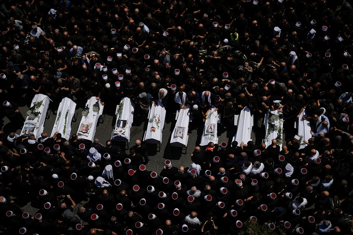  (AP Photo/Leo Correa, File) : Mourners from the Druze minority surround the bodies of some of the 12 children and teens killed in a rocket strike at a soccer field, in the village of Majdal Shams at the Israeli-controlled Golan Heights, Sunday, July 28, 2024. Two back-to-back strikes in Beirut and Tehran, both attributed to Israel and targeting high-ranking figures in Hezbollah and Hamas, have left Hezbollah and Iran in a quandary.