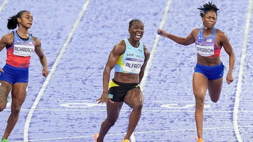 Julien Alfred, of Saint Lucia (c) crosses the finish line ahead of Sha'carri Richardson (left) of the United States, and Melissa Jefferson, of the United States - AP/Martin Meissner
