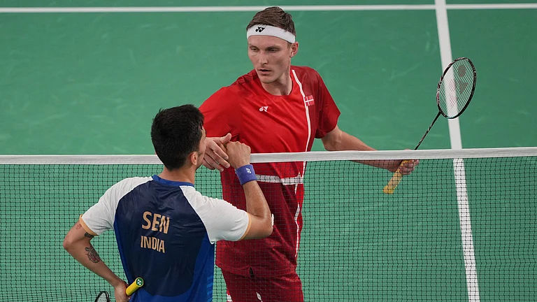Denmark's Viktor Axelsen, right, celebrates after defeating India's Lakshya Sen during their men's singles badminton semifinal match at the 2024 Summer Olympics, Sunday, Aug. 4, 2024, in Paris, France. - Kin Cheung