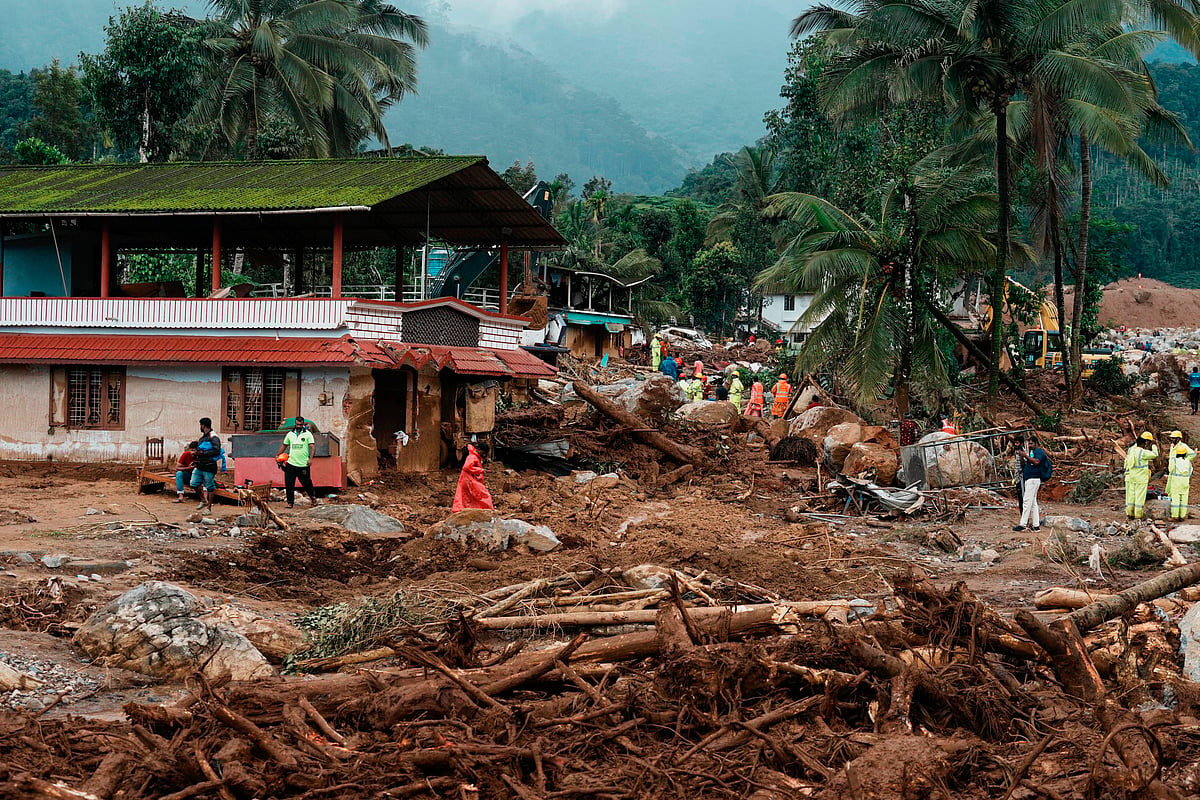 AP : Rescuers on their second day of mission following Tuesday’s landslides work next to a damaged house at Chooralmala, Wayanad district, Kerala.