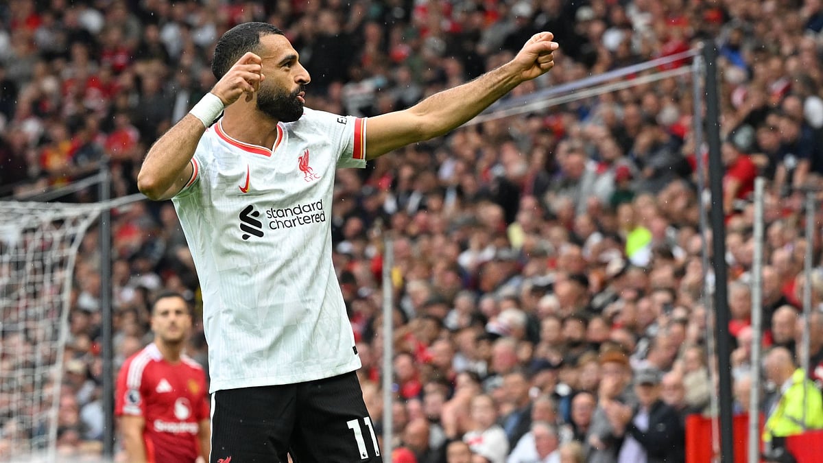Salah celebrates his goal in the 3-0 win - null