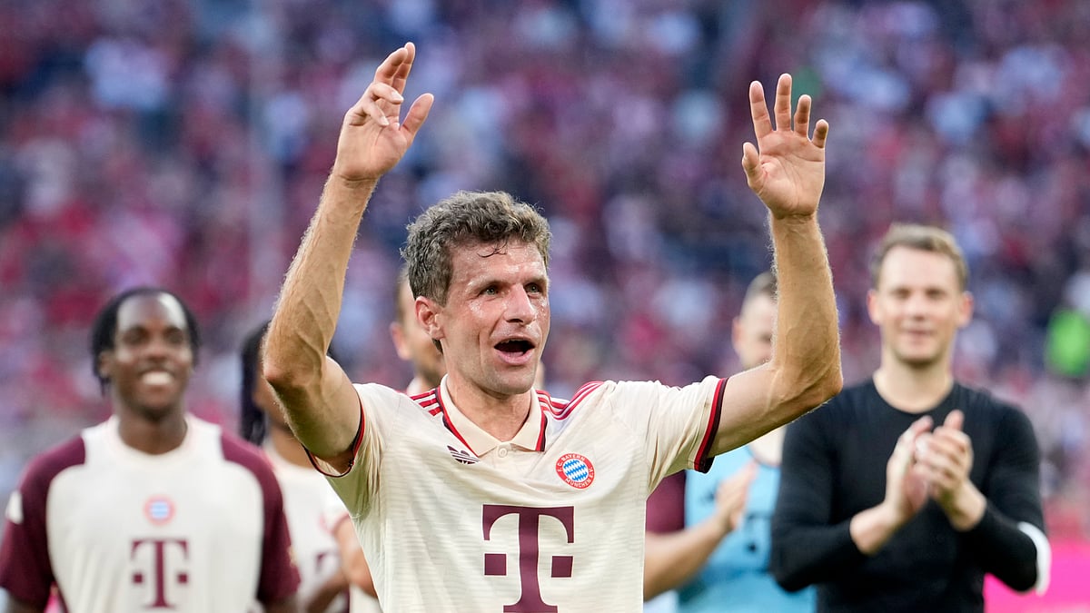 Thomas Muller celebrates with Bayern Munich supporters after Sunday's victory.