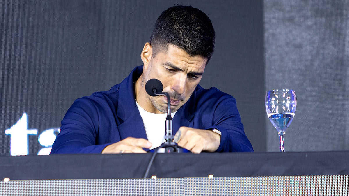 Luis Suarez cries while announcing his international retirement at a press conference
