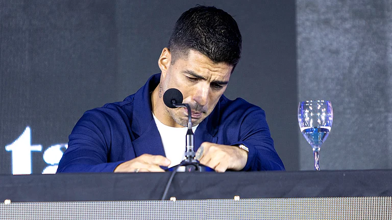Luis Suarez cries while announcing his international retirement at a press conference - null