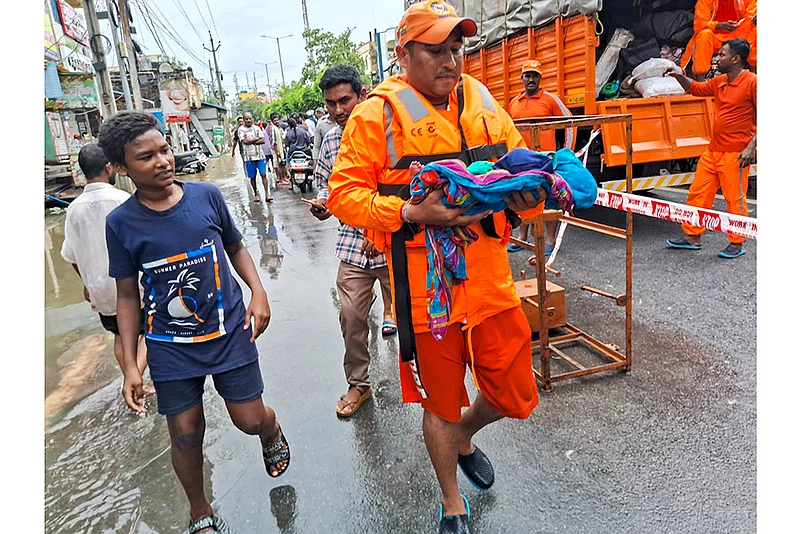 Vijayawada: NDRF men evacuate an infant from a flood -hit area