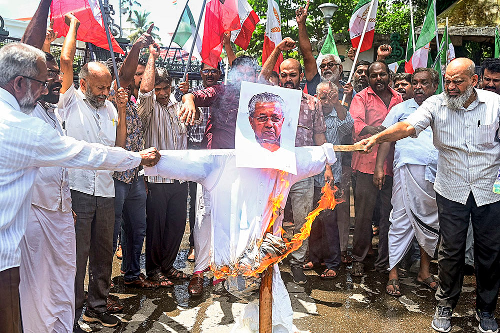 Activists of Welfare Party of India burn an effigy of Kerala Chief Minister Pinarayi Vijayan