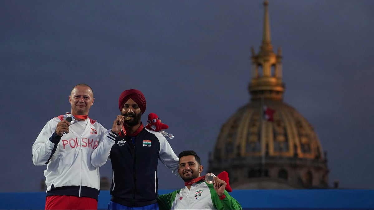 Harvinder Singh of India, center, Lukasz Ciszek of Poland, left, and Mohammad Reza Arab Amiri of Iran celebrate on the podium after the men's Individual Recurve Open, during the 2024 Paralympics, Wednesday, Sept. 4, 2024, in Paris, France. - AP/PTI