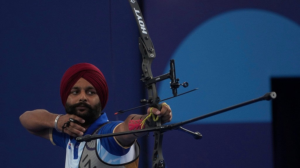 Photo: AP : India's gold-winning archer Harvinder Singh in action at the Paris Paralympics. 