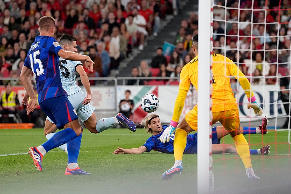 Portugals Diogo Dalot, scores an own goal during the UEFA Nations League soccer match