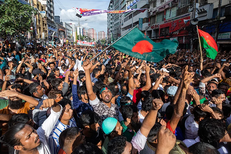People gather in front of the Bangladesh Nationalist Party (BNP) headquarters during a rally in Dhaka - via AP