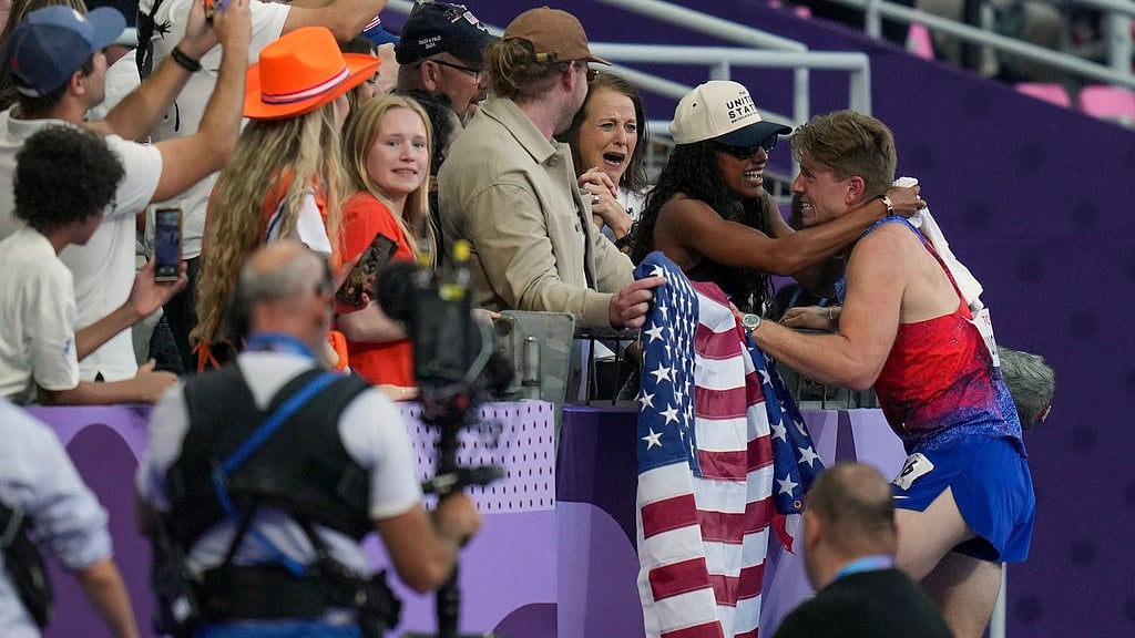 Hunter Woodhall (right) hugs his wife and Paris 2024 gold medallist Tara Davis-Woodhall, after himself winning the men's 400 m T62 final at the 2024 Paralympics on Friday (September 6).  - AP/Thibault Camus