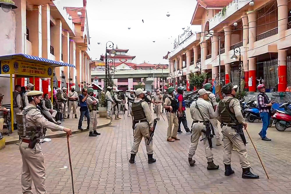 Security personnel stand guard during Curfew in Imphal West district