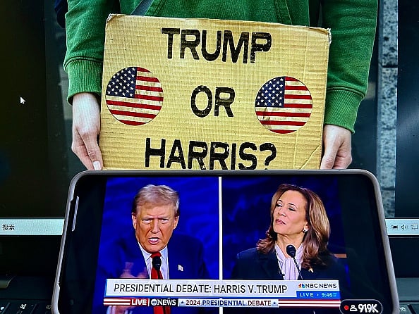 Getty Images : A smartphone screen shows the live broadcast of presidential debate
