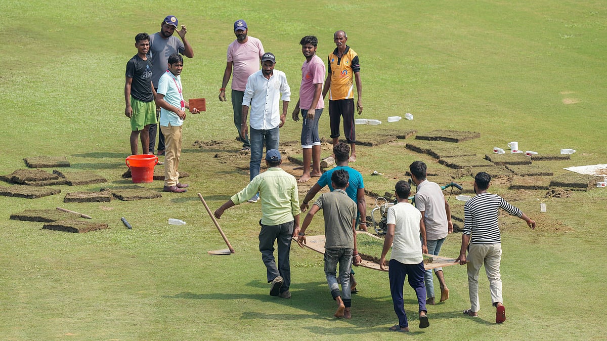 PTI/Kamal Kishore : Groundsmen putting grass patches in an unsuccessful bid to get play underway in the one-off Test match between Afghanistan and New Zealand in Greater Noida. 