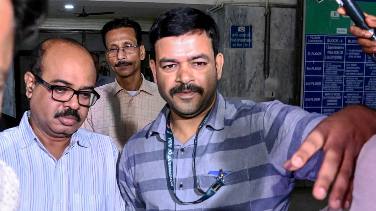 CBI officials take Tala Police Station Officer-in-Charge Abhijit Mondal (L) to produce him in court after his arrest. - PTI
