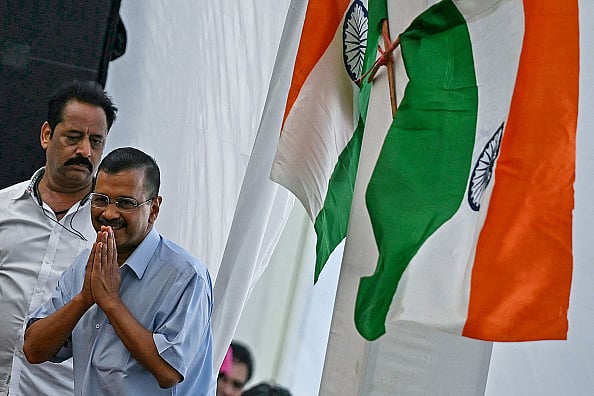 (Photo via Getty Images) : Arvind Kejriwal (R), Chief Minister of the capital Delhi and leader of the Aam Aadmi Party (AAP), greets his supporters and party workers at the AAP's headquarters before returning to prison in New Delhi on June 2, 2024.