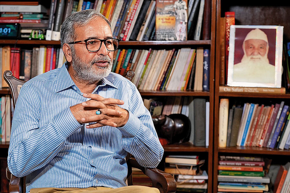 Photo: Suresh K. Pandey : In Living Memory: Qurban Ali at home with his father Captain Abbas Ali’s photo in the background