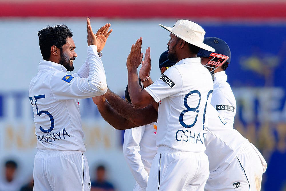 | Photo: AP/Viraj Kothalawala : SL Vs NZ, 1st Test Day 2: Sri Lanka's captain Dhananjaya de Silva, left, celebrates the wicket of New Zealand's Rachin Ravindra