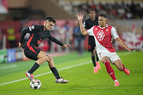 UEFA Champions League, Monaco and Barcelona: Barcelona's Pedri, left, controls the ball past Monaco's Vanderson