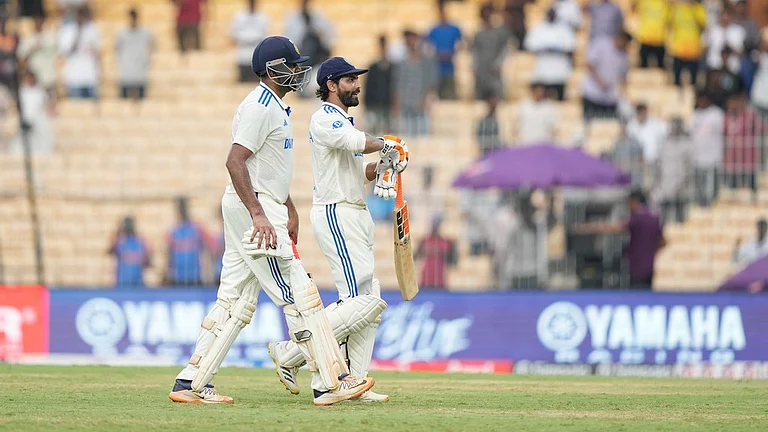 India's Ravichandran Ashwin, left, and Ravindra Jadeja leave the field at the end of the first day of the first cricket Test match. - AP/Mahesh Kumar A.