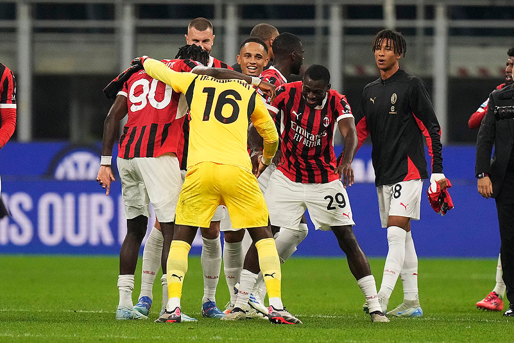 | Photo: AP/Luca Bruno : Serie A Soccer, Inter Milan Vs AC Milan: AC Milan's team players celebrate after the match