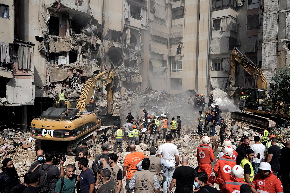 AP : Emergency workers use excavators to clear the rubble at the site of Friday's Israeli strike in Beirut's southern suburbs, Saturday, Sept. 21, 2024. 