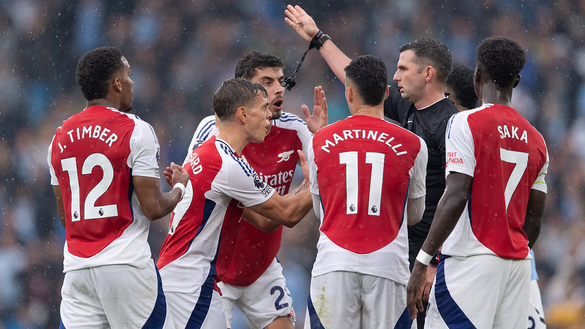 Arsenal's players surround Michael Oliver following Leandro Trossard's red card