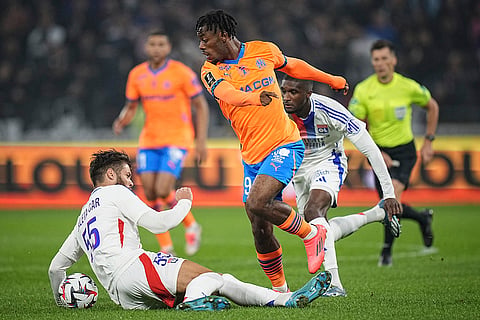 Ligue 1 Soccer, Marseille vs Lyon: Marseille's Elye Wahi, center, challenges Lyon's Duje Caleta-Car, left, for the ball