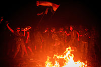 Myanmar’s Unending War: Military Junta Possibly On Decline But Ethnic Crisis Still Unheeded via Getty Images : Members of Karenni Resistance Force celebrate mission accomplishment in their base, in Shadaw Township.