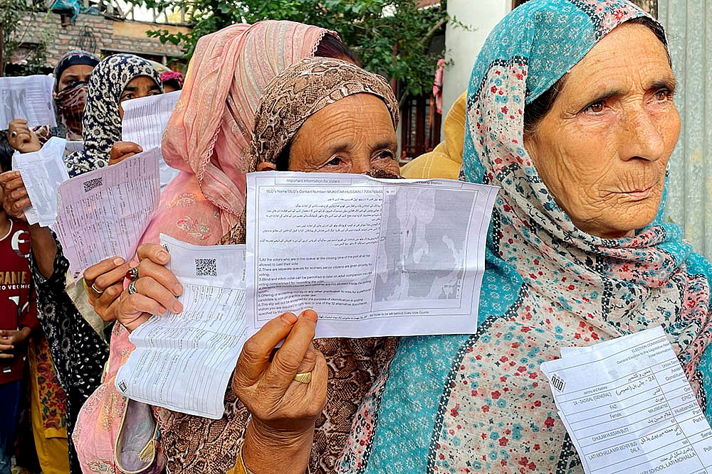 | Photo: PTI/S Irfan : Women voters stand in a queue to cast their votes in Srinagar