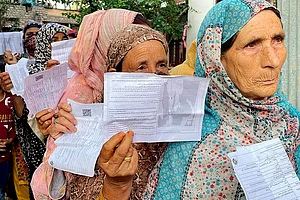 | Photo: PTI/S Irfan : Women voters stand in a queue to cast their votes in Srinagar