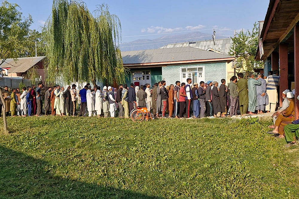 | Photo: PTI : Voters stand in a queue to cast votes at a polling center at Khan Sahib in Budgam district during the second phase.