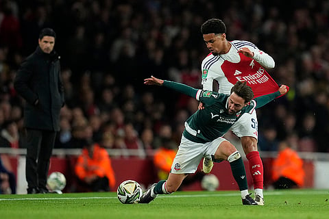 EFL Cup, Arsenal vs Bolton Wanderers: Bolton's Josh Sheehan, left, fights for a ball with Arsenal's Ethan Nwaneri 