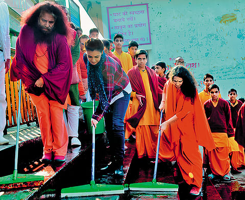 Swami Chidanand Saraswati, film actress  Dia Mirza and Sadhvi Bhagawati Saraswati engaged in a cleaning drive