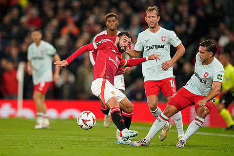 UEFA Europa League, Manchester United vs Twente: Manchester United's Bruno Fernandes, left, and Twente's Bart van Rooj, right, challenge for the ball
