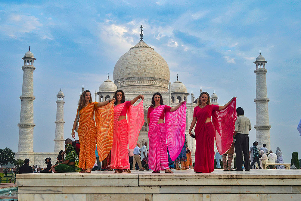 Foreign tourists wearing sarees at Taj Mahal