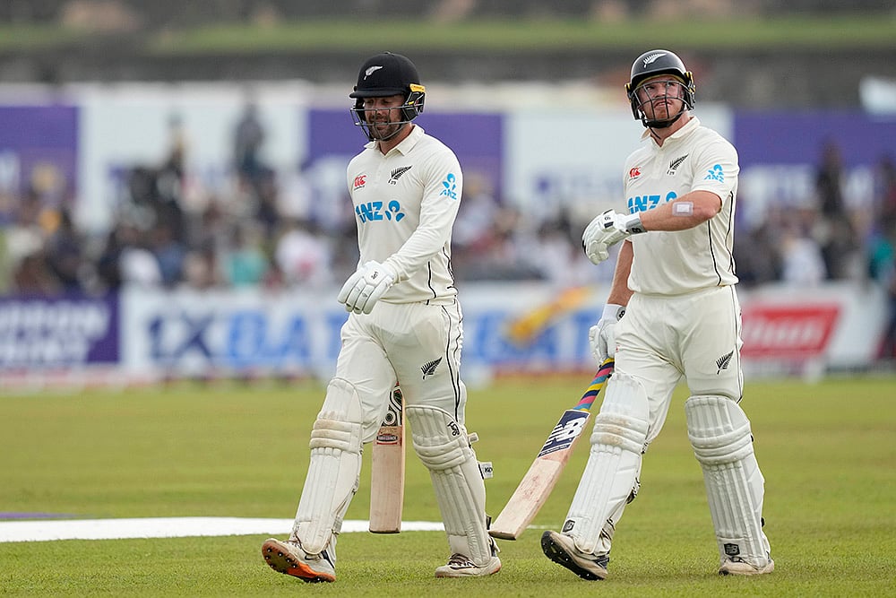 | Photo: AP/Eranga Jayawardena : Sri Lanka Vs New Zealand 2nd Test: New Zealand's Glenn Phillips and Tom Blundell leave the filed after the play interrupted due to bad light