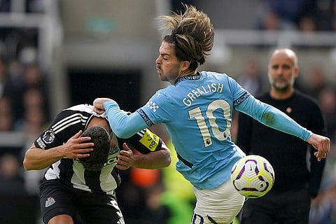 EPL 2024-25, Newcastle vs Manchester City: Newcastle United's Fabian Schar, left, and Manchester City's Jack Grealish battle for the ball 