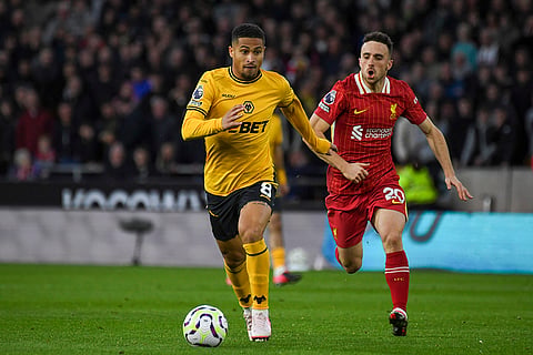 English Premier League 2024-25, Wanderers vs Liverpool: Wolverhampton Wanderers' Joao Gomes, center, is chased by Liverpool's Diogo Jota
