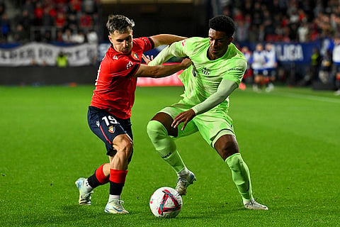 La Liga 2024-25, Osasuna and Barcelona: Osasuna's Bryan Zaragoza fights for the ball against Barcelona's Alejandro Balde 