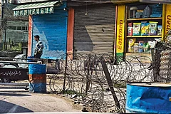Photo: Yasir Iqbal : Sights of Silence: A man standing next to a checkpoint in downtown Srinagar