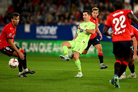 La Liga 2024-25, Osasuna and Barcelona: Barcelona's Robert Lewandowski fights for the ball against Osasuna's Lucas Torro