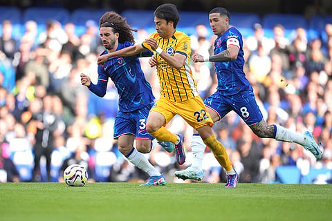 English Premier League 2024-25, Chelsea vs Brighton: Chelsea's Marc Cucurella, left, Brighton's Kaoru Mitoma, center, Chelsea's Enzo Fernandez compete for the ball