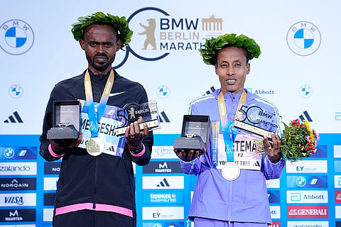 Berlin Marathon: The winner Milkesa Mengesha, left men, and Tigist Ketema, right women, pose for media