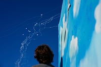 Middle East Conflict: Links To Jerusalem, Iran's Support For Gaza, Its Allies Hezbollah, Houthis - Explained AP : A man looks at the Israeli Iron Dome air defense system as it fires to intercept rockets that were launched from Lebanon, in Safed, northern Israel, Sunday, Sept. 29, 2024.