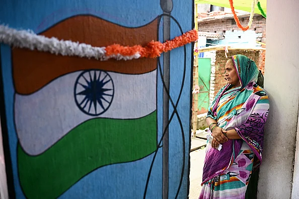 A voter waits to cast her ballot at a polling station