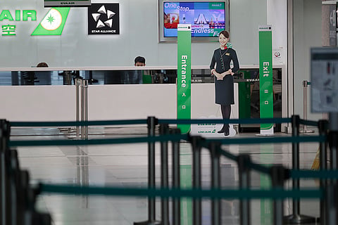 Taiwan Typhoon Krathon: Airline staff work at the counter at a closed airport
