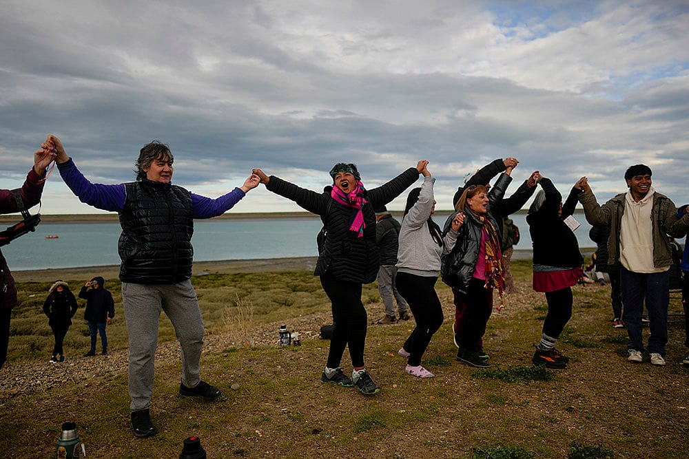 People join hands during an annular solar eclipse in Puerto San Julian